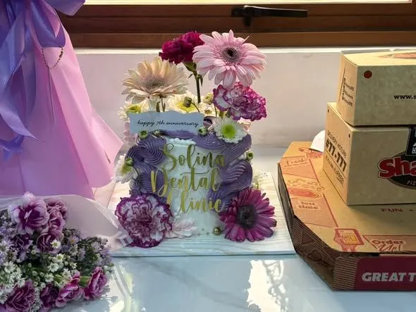 Anniversary flowers and cake on the clinic counter