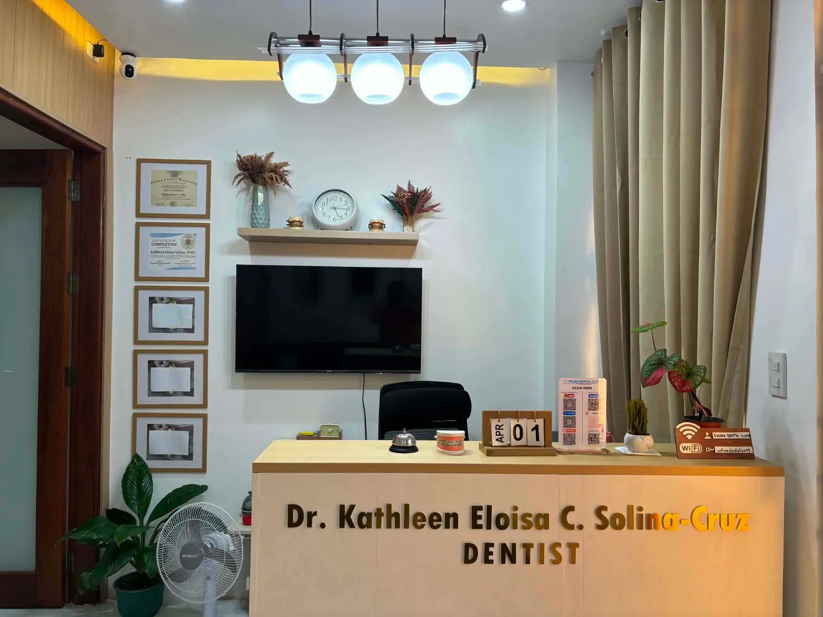 Reception with pendant lights, framed certificates and Doc Kath’s nameplate